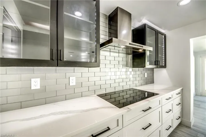 Bathroom with vanity, recessed lighting, and a shower