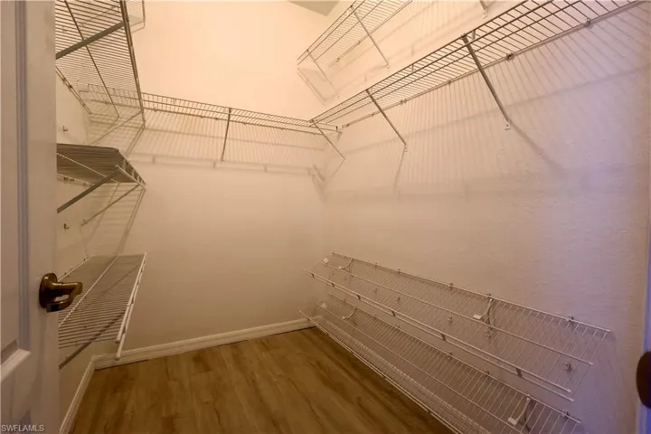 Spacious closet with wood finished floors