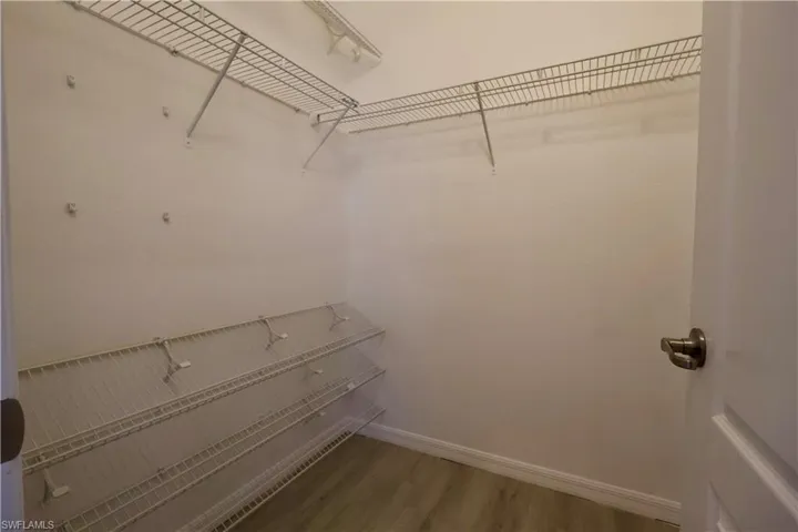 Walk in closet featuring wood finished floors