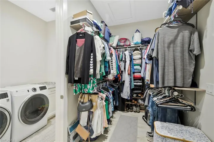 Primary Walk-in Closet with access to laundry room.