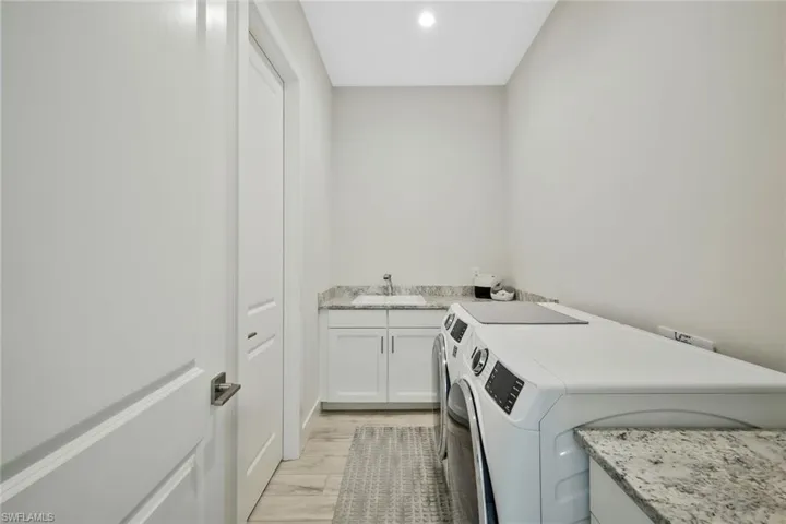 Laundry Room with front load smart washer and dryer.
