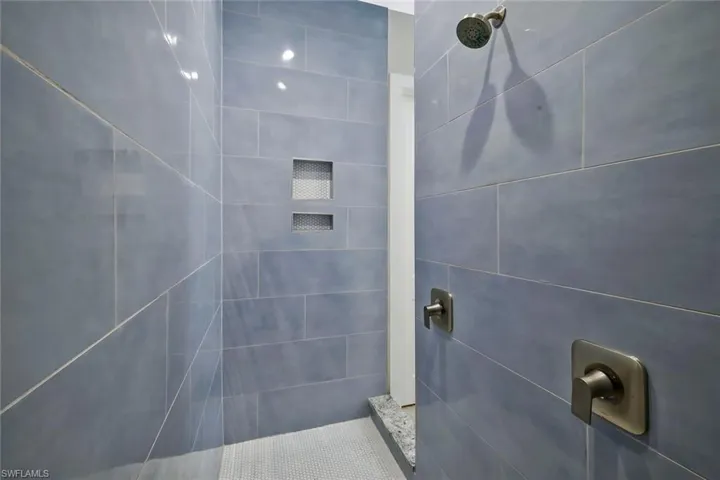Custom walk-through shower with duel showerheads.