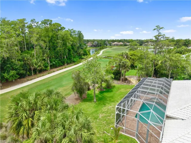 Enjoy a premium golf course location overlooking the 13th hole of the Loch Ness Golf Course, where a picturesque golf cart path, mature trees, and generous setbacks enhance the sense of space and privacy.