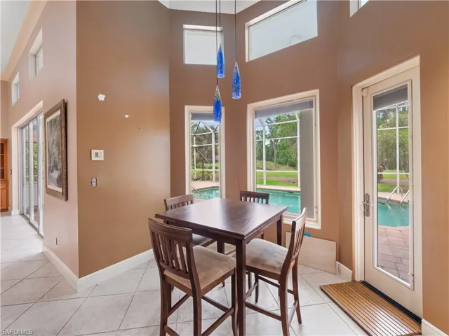 The breakfast nook captures the essence of Florida living with pool views, natural light, and easy access to the screened lanai.