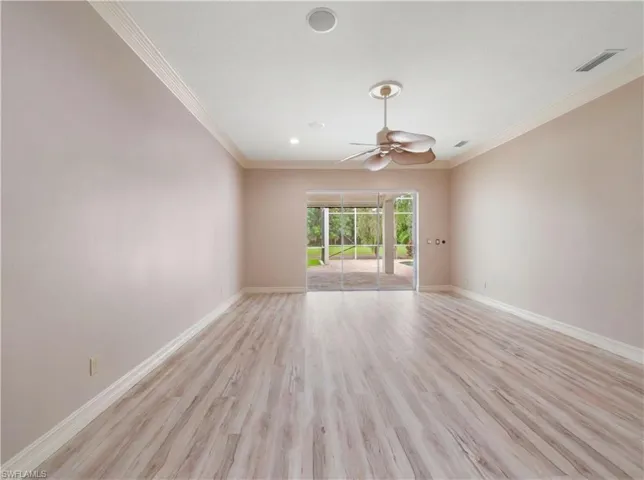 Designed as a private retreat, the primary bedroom offers exceptional space, natural light, and convenient access to the lanai and pool area.