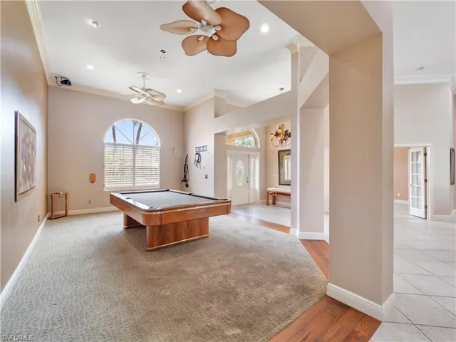 Generously sized flex space with soaring ceilings and abundant natural light, ideal as a billiards room, formal dining area, or entertainment space.