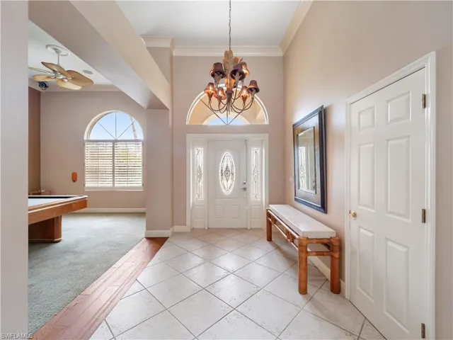 Welcoming entry foyer with soaring ceilings and abundant natural light, creating an immediate sense of openness upon arrival.