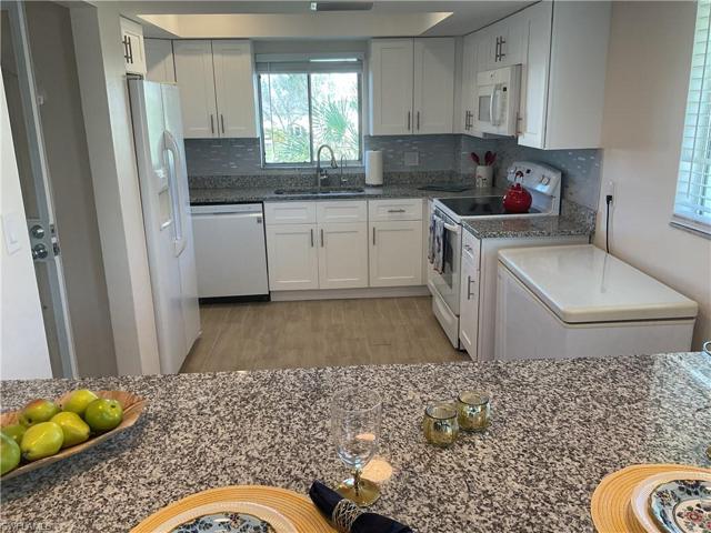 Kitchen with new granite counter tops and white cabinets
