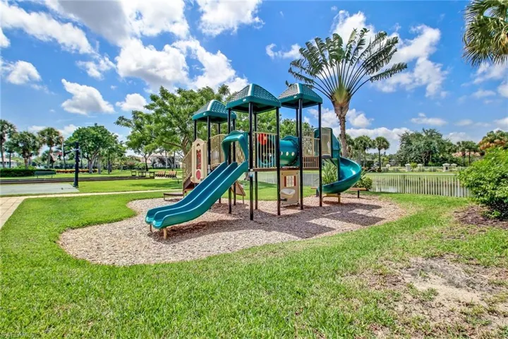 View of jungle gym with a lawn