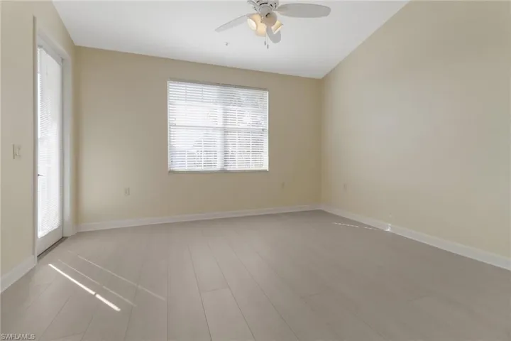 Unfurnished room with ceiling fan and light hardwood / wood-style flooring