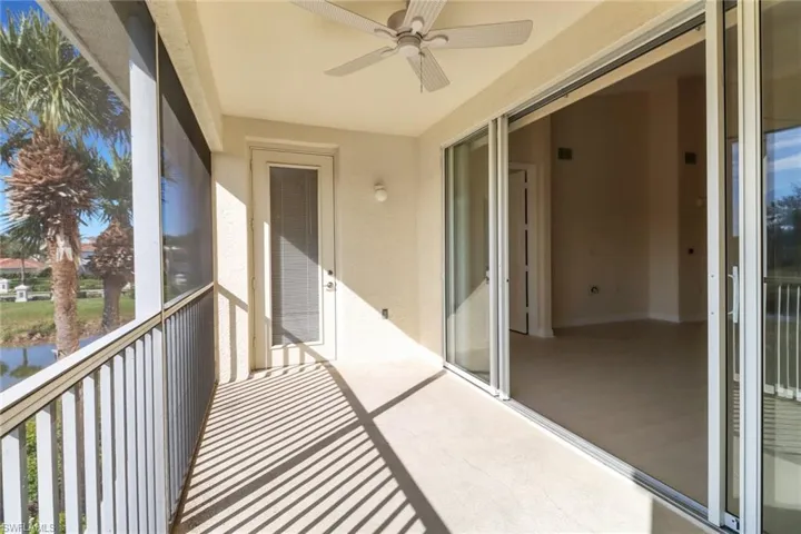 Unfurnished sunroom featuring ceiling fan