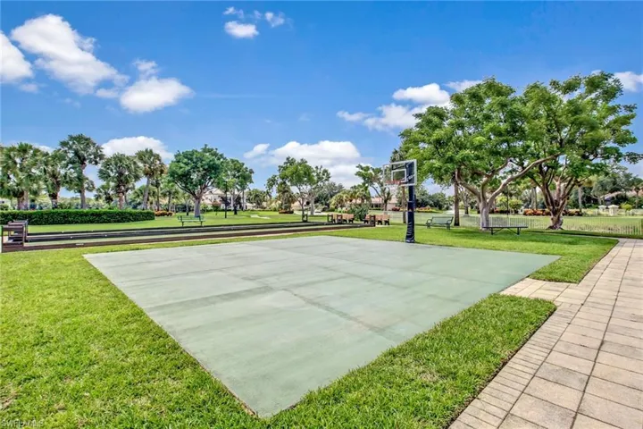 View of sport court with a yard