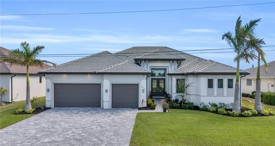 View of front of home featuring a garage and a front lawn
