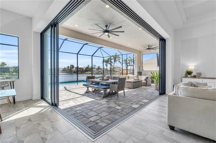 View of patio featuring a lanai, outdoor lounge area, and ceiling fan