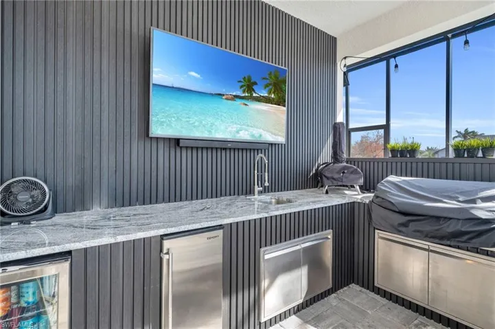 View of patio / terrace featuring wine cooler and sink
