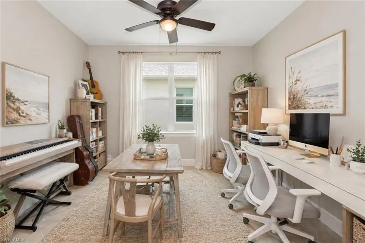 Versatile room featuring a ceiling fan with integrated lighting, a window with blinds, and light-toned wall finishes