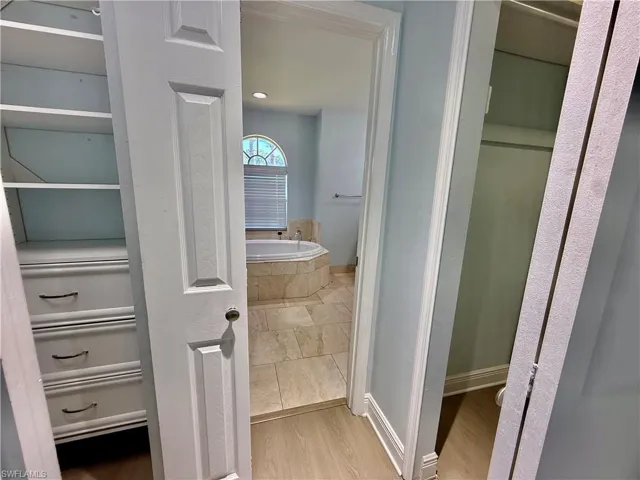 Dual walk in closets with built in shelving.