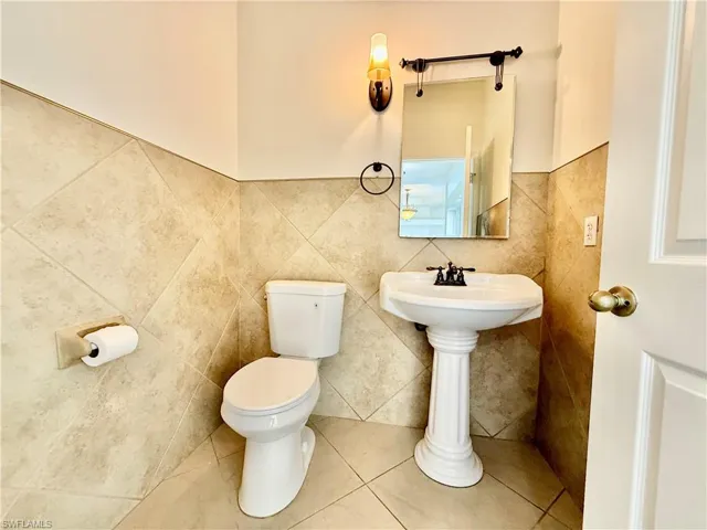 Half bath off of the entry for guest.