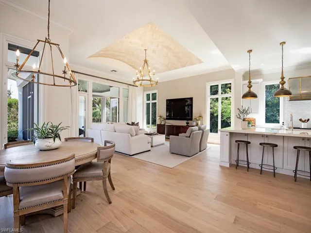 Dining space featuring a chandelier, light wood-type flooring, and crown molding