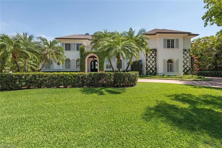 Mediterranean / spanish house featuring stucco siding and a front yard