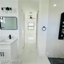 Full bathroom with vanity and a stall shower