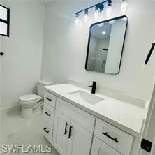 Bathroom with vanity and toilet