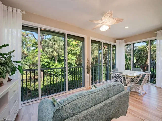 Sunroom with plenty of natural light and views of creek and preserve