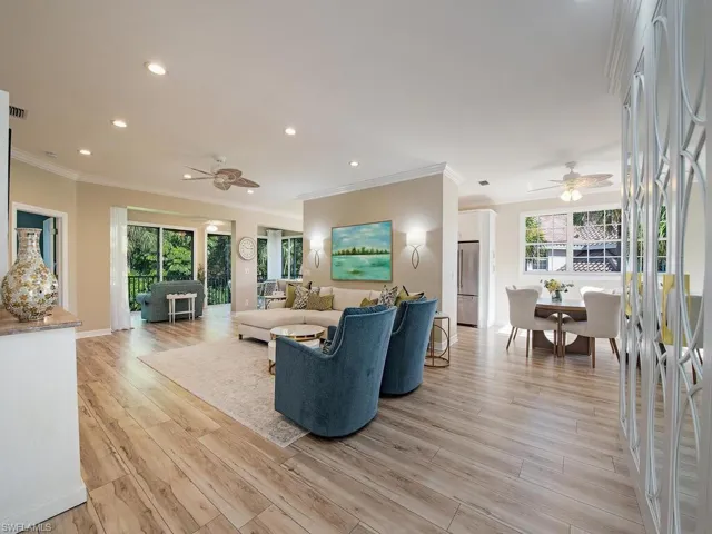 Great room adjacent to formal dining area with views of lanai and preserve
