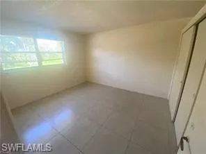 Spare room with tile patterned flooring