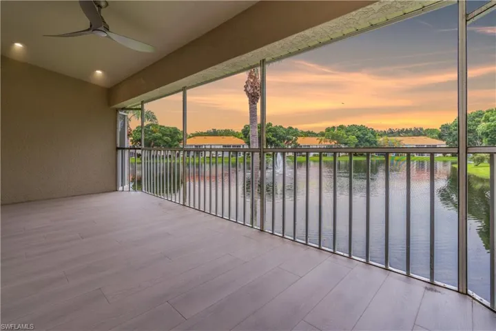 Lanai at dusk featuring a water view and ceiling fan
