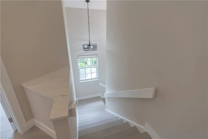 Stairs featuring wood-style flooring, natural sunlight