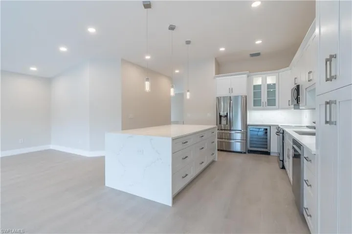 All new stainless steel appliances, wine cooler with above glass cabinet, pantry cabinet, dual side storage in island
