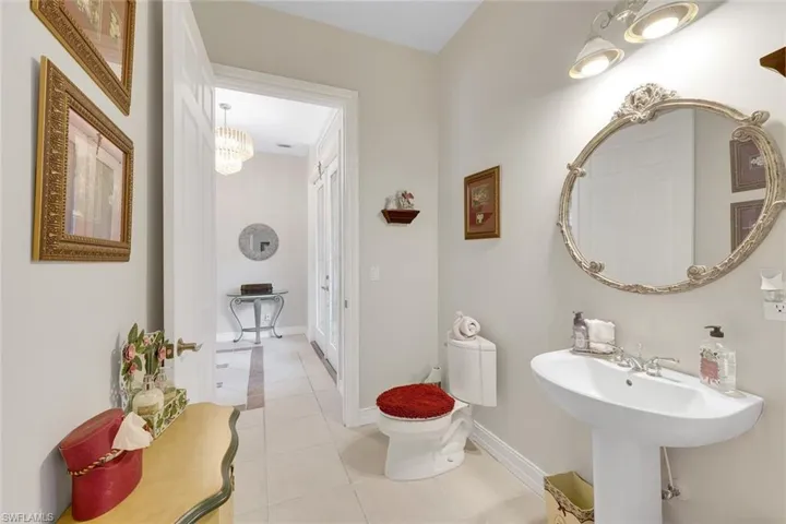 Bathroom featuring light tile patterned flooring and hanging lights