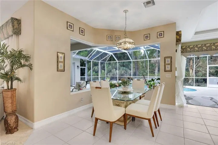 Dining area with a sunroom and tile patterned flooring
