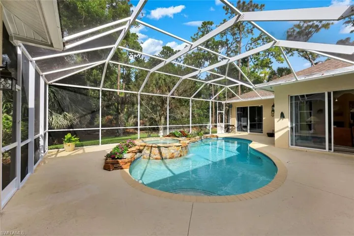 Integrated pool / hot tub with a patio area, a lanai, and a sunroom