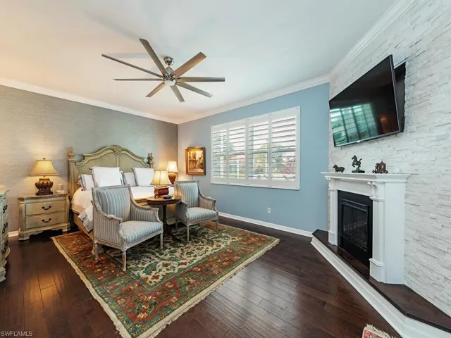 3760 Baldwin Ln, Naples FL 34116 - First floor owner's bedroom with fireplace and stacked stone accent wall