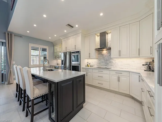 3760 Baldwin Ln, Naples FL 34116- A Chef's kitchen with island seating, Cabinet drawers and lower cabinet pull-outs.