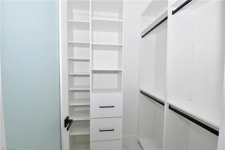 Primary bedroom walk-in closet