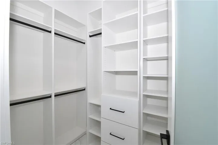 Primary bedroom walk-in closet