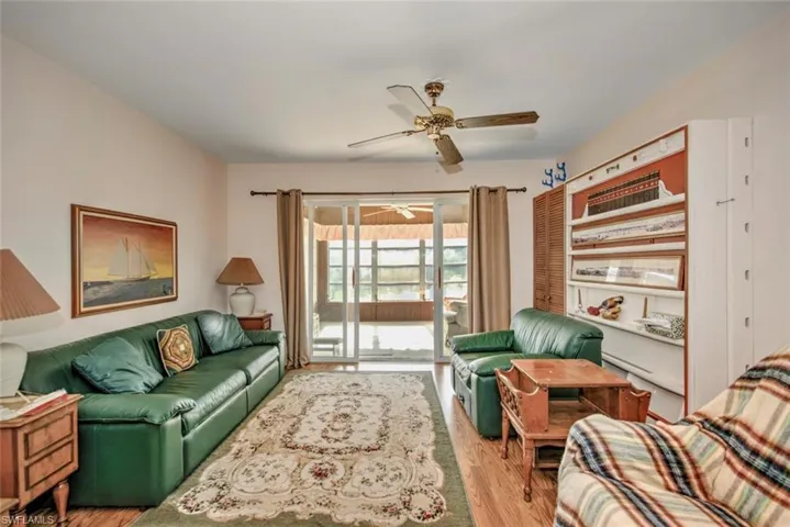 Living room featuring ceiling fan and light hardwood / wood-style flooring