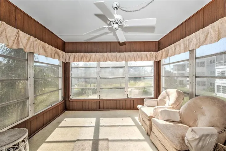 Sunroom / solarium featuring ceiling fan