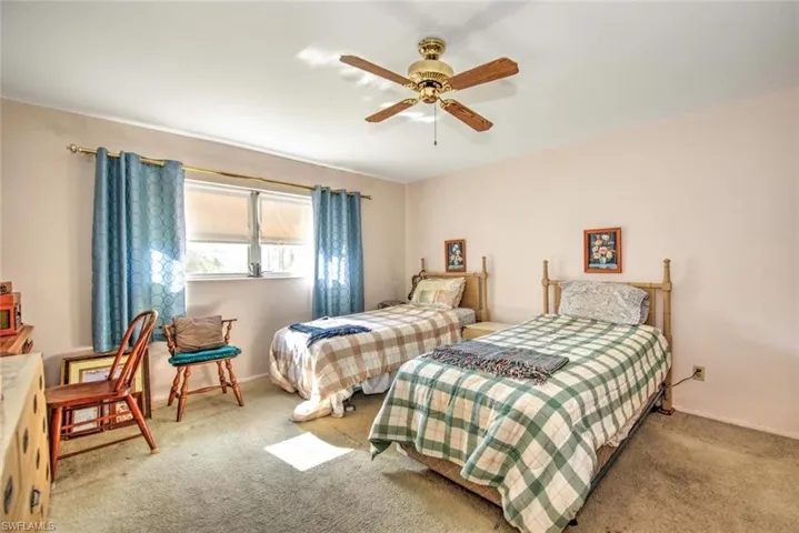 Bedroom featuring light carpet and ceiling fan