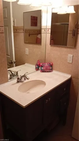 Bathroom with tile walls and vanity