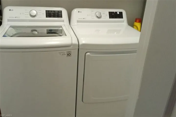 Laundry room with washing machine and clothes dryer