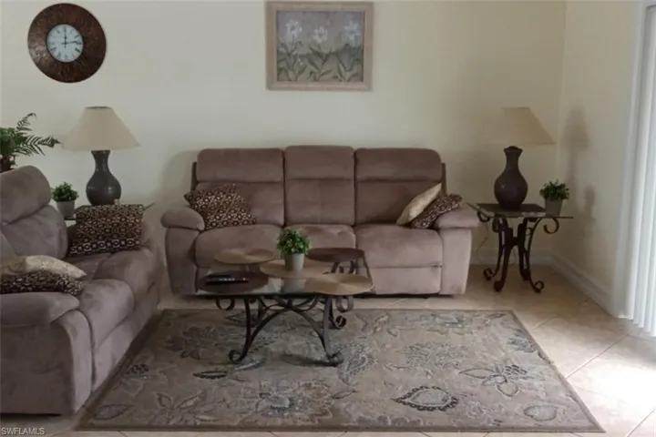 Living area with tile patterned floors and baseboards