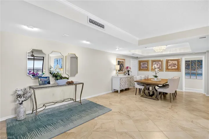 Foyer entrance into living room and dining area