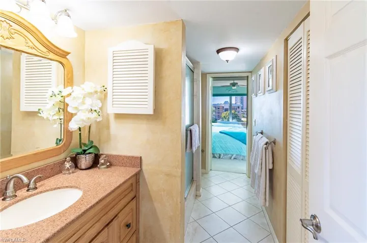 Bathroom featuring tile patterned flooring, vanity, and ceiling fan
