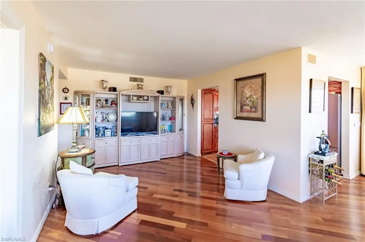 Living room with dark hardwood / wood-style floors