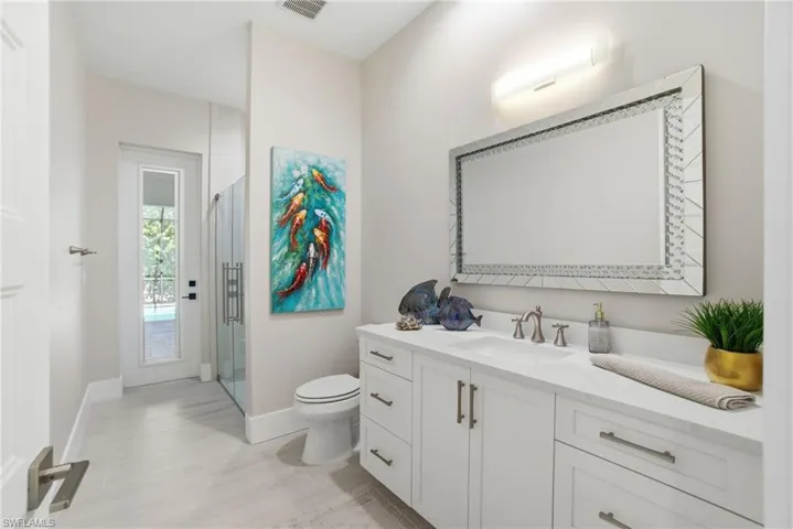 Full bathroom with vanity and access to lanai