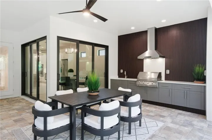 Outdoor dining area with outdoor kitchen and grill